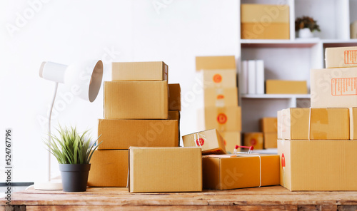 Cardboard boxes on storage warehouse put on wooden desk. © makibestphoto