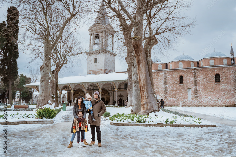family tourist visiting topkapi palace in istanbul during winter and snow fall
