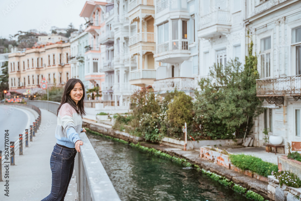beautiful woman exploring bebek bosphorus area enjoying the beauty of historical building in arnavutkoy beautiful woman exploring bebek bosphorus area enjoying the beauty of historical building in arnavutkoy