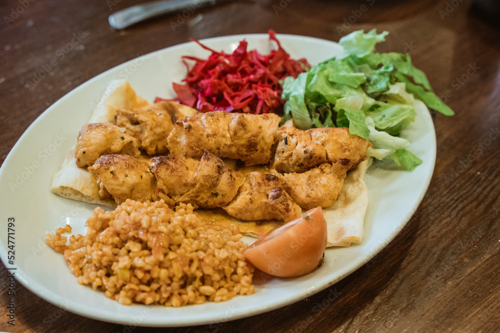 close up chicken grilled served with rice and pita bread and fresh vegetables close up chicken grilled served with rice and pita bread and fresh vegetables