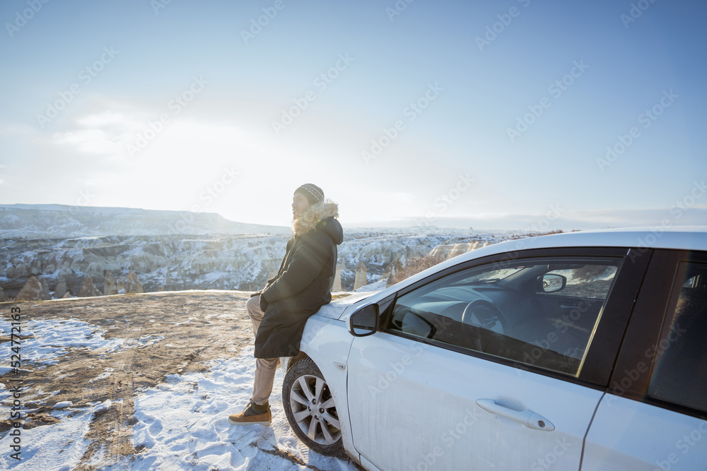 portrait of young asian man on his adventure going to beautiful hill in cappadocia in winter by his car portrait of young asian man on his adventure going to beautiful hill in cappadocia in winter by his car