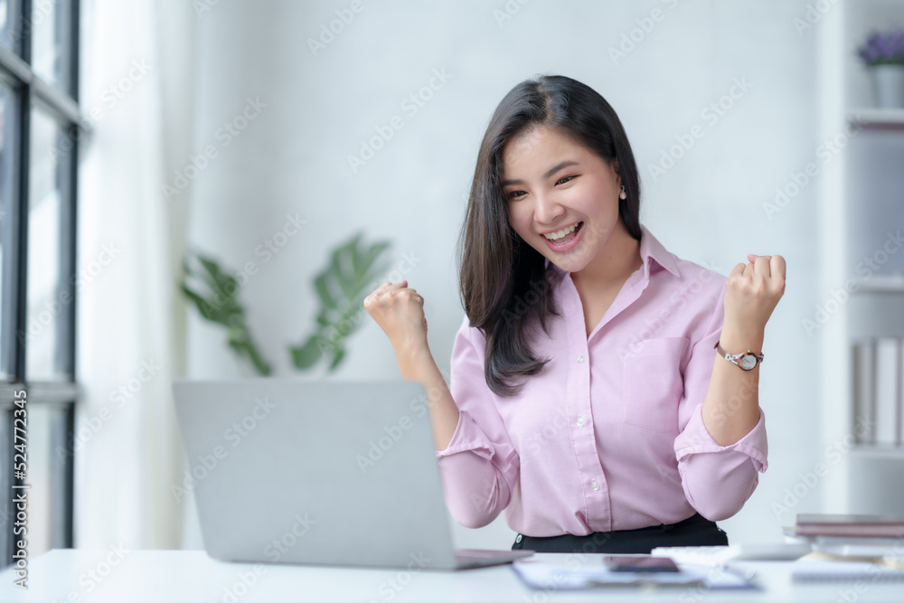 Cheerful and beautiful Asian businesswoman is excited and delighted that she has successfully accomplished her goals beautifully. Cheerful and beautiful Asian businesswoman is excited and delighted that she has successfully accomplished her goals beautifully.