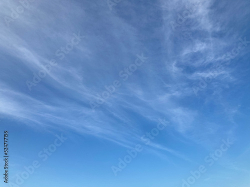light pale white clouds on the blue sky in natural daylight, using for the background