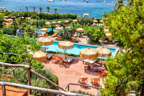 Fototapeta Naklejka Na Ścianę i Meble -  Rustic stairs and pathways amongst the colourful beach chairs and umbrellas in the hot springs on the island of Ischia in Italy
