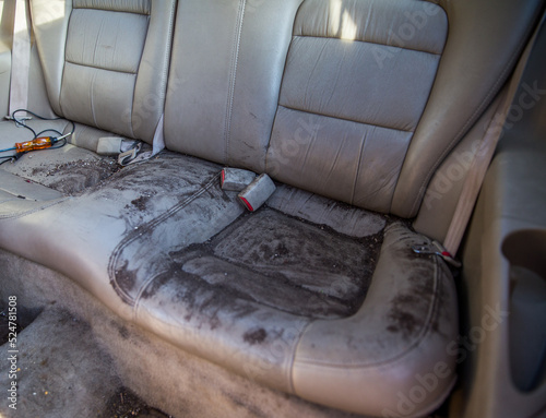 Dirt filled back seat of vehicle