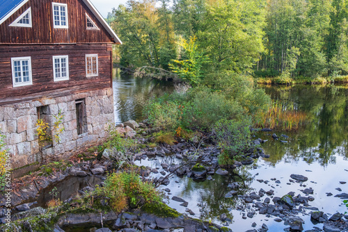 Old Mill house at a river in the woodland