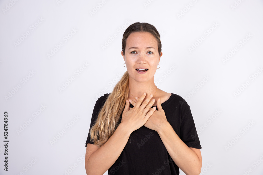 Portrait of mid adult Caucasian woman feeling sorry. Girl standing and apologizing over white background. Excuse concept Portrait of mid adult Caucasian woman feeling sorry. Girl standing and apologizing over white background. Excuse concept