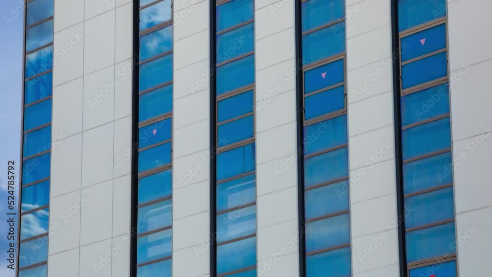 A timelapse of cloud reflecting the building in the business town long shot zoom