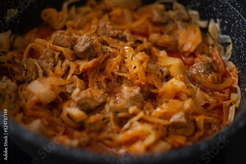 Stewed cabbage in a frying pan. Cooking recipe.