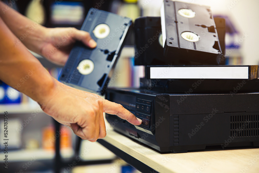 Fototapeta premium Close-up hand press button on video record playback concept of vintage electric and electronic appliances multimedia player device old fashioned.