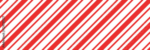 Christmas candy cane striped seamless pattern. Christmas candycane background with red stripes. Caramel diagonal print. Xmas traditional wrapping texture. Vector illustration.