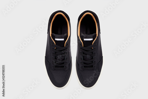 Classic leather male pair of slip-on sneakers. Men's sports shoes for gym running jogging isolated on white background. Placed together, view from above