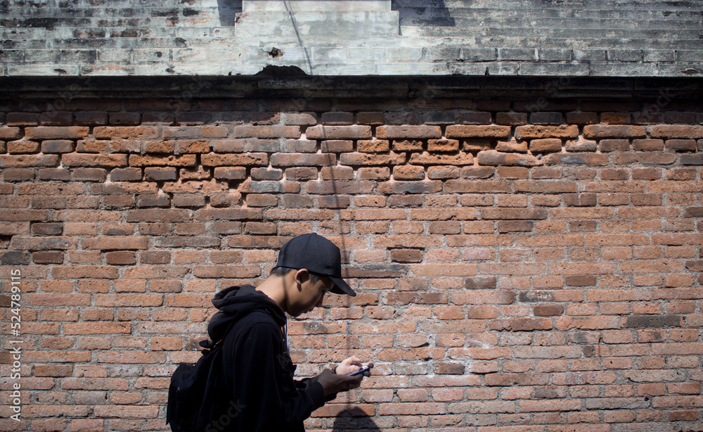 man walking looking at smartphone man walking looking at smartphone