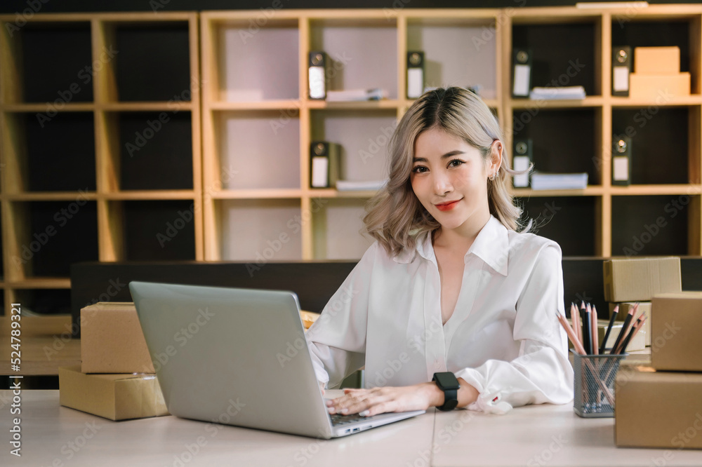 Woman hand using laptop, smartphone and tablet and writing notebook at office of her business online shopping. In home . Woman hand using laptop, smartphone and tablet and writing notebook at office of her business online shopping. In home .