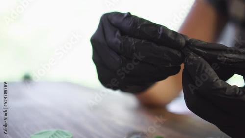 Working process, creation of polymer clay leaf. Craftsman at job. Close up, soft selective focus.