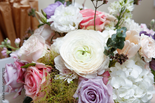 A view of a beautiful spring bouquet of flowers, featuring Persian buttercup, roses, hydrangea, and carnation.
