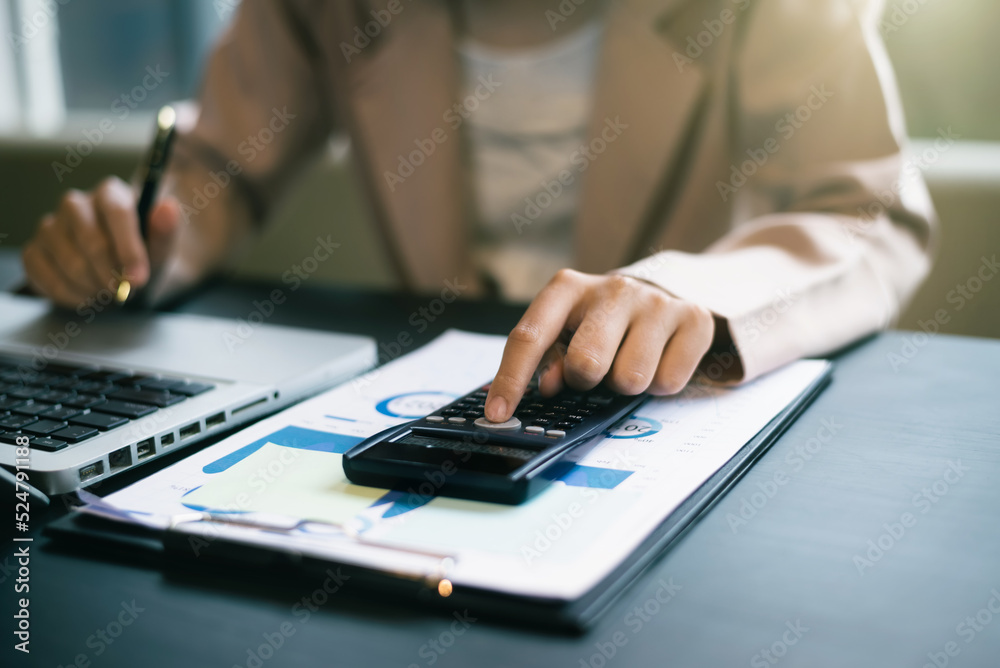Business women using calculator with computer laptop, Business accounting, budget and loan paper in office. Business women using calculator with computer laptop, Business accounting, budget and loan paper in office.