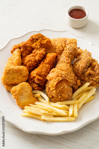 fried chicken with french fries and nuggets on plate