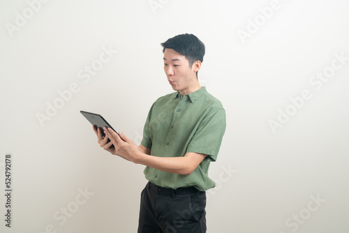 young Asian man using tablet