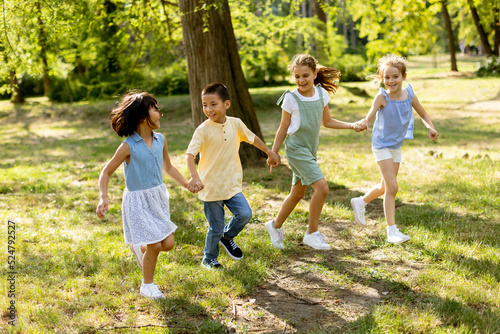 Group of asian and caucasian kids having fun in the park