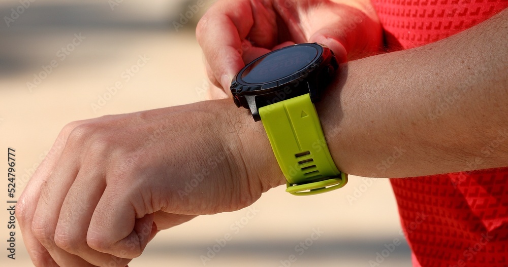 Smartwatch wearable smart tech fitness active athlete man using sports watch  on exercise cardio workout checking his heart rate. Photos | Adobe Stock