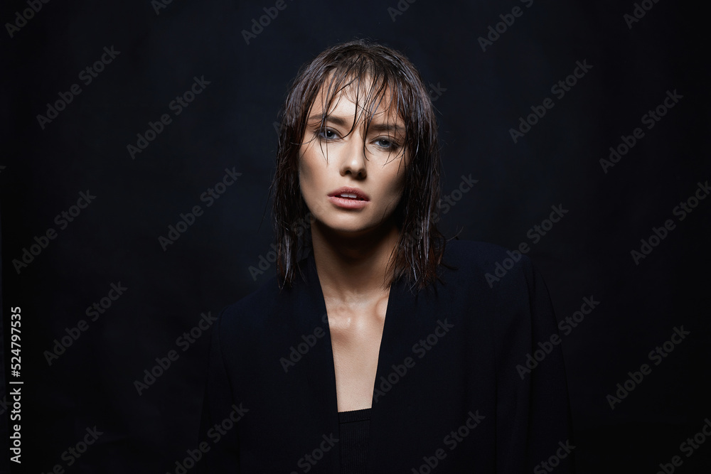 beautiful girl standing in the dark. young wet hair woman