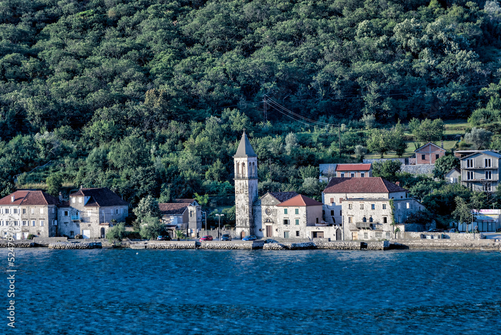 Kotor, Montenegro - July 18, 2022: Shoreline buildings and piers outside of Kotor, Montenegro
