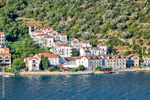 Kotor, Montenegro - July 18, 2022: Shoreline buildings and piers outside of Kotor, Montenegro 