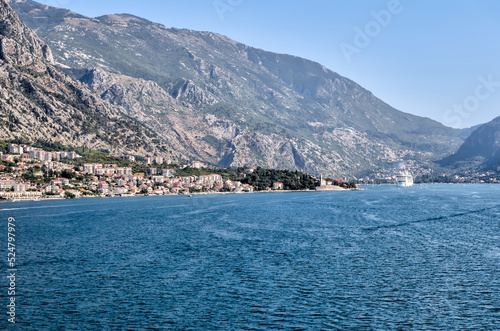 Kotor, Montenegro - July 18, 2022: Shoreline buildings and piers outside of Kotor, Montenegro 