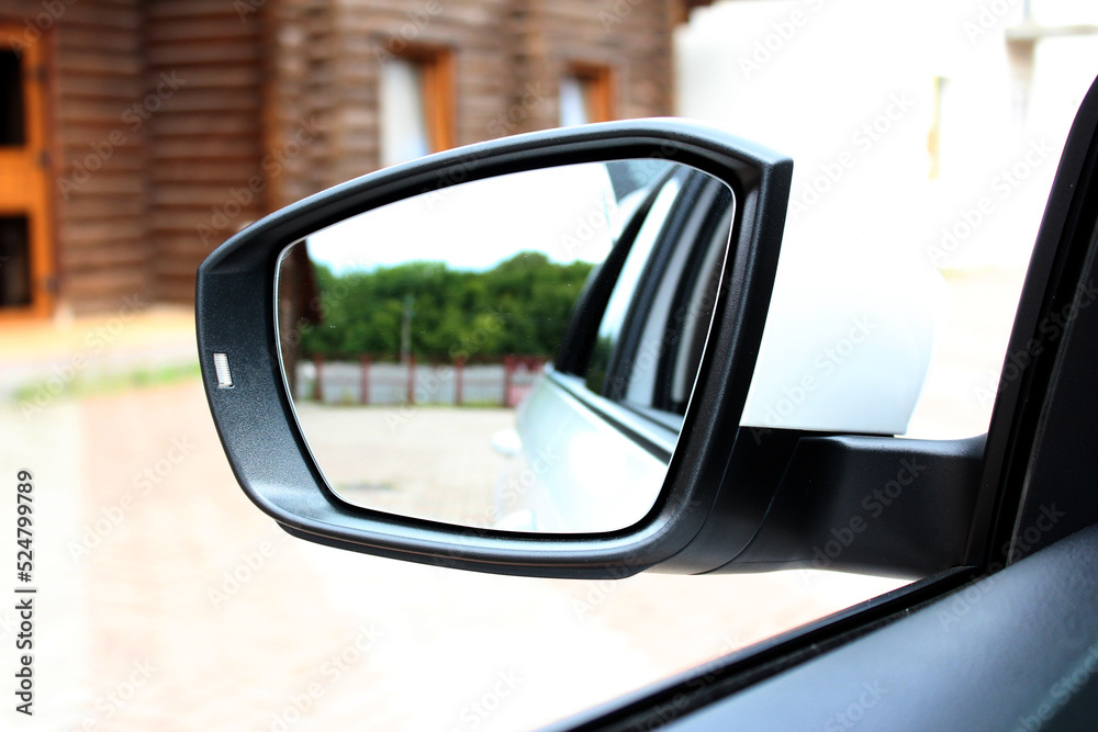 Rear view mirror with beautiful reflection. Side rear-view mirror on a modern car. Close up rearview mirror lux car.
