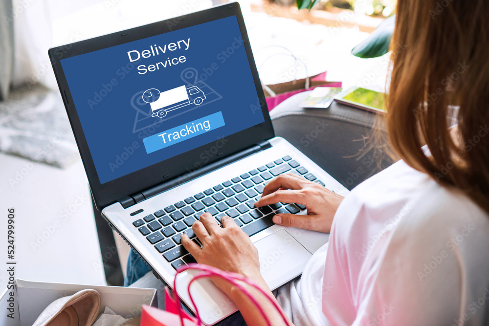 Woman using computer with app tracking parcel online to update status and delivery service status. Online shopping, Tracking, delivery , technology and lifestyle concept. Woman using computer with app tracking parcel online to update status and delivery service status. Online shopping, Tracking, delivery , technology and lifestyle concept.