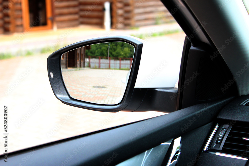 Rear view mirror with beautiful reflection. View from inside the car. Side rear-view mirror on a modern car. Close up rearview mirror lux car.