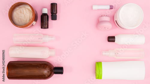 Creative layout of cosmetics products with copy space on pastel pink background. Flat lay