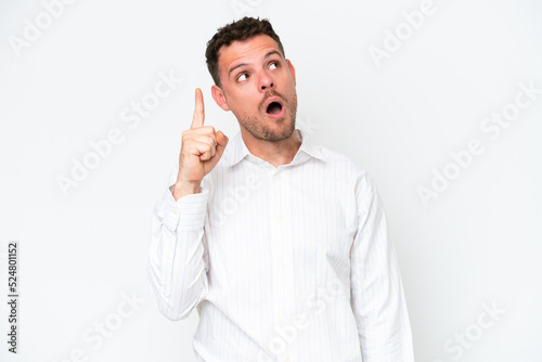 Young caucasian handsome man isolated on white background intending to realizes the solution while lifting a finger up