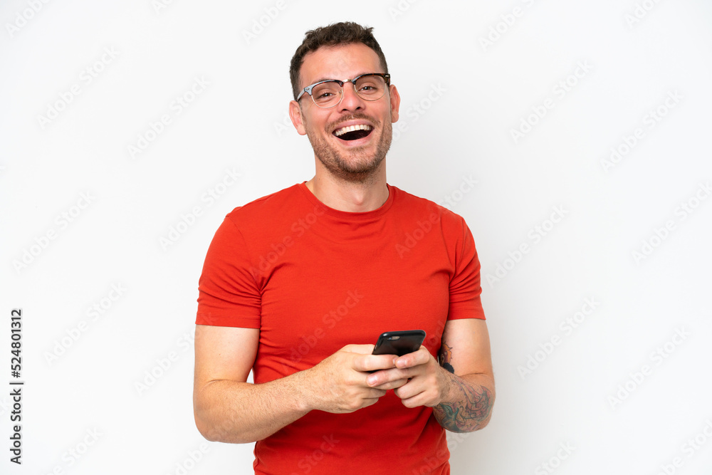 Young caucasian handsome man isolated on white background surprised and sending a message