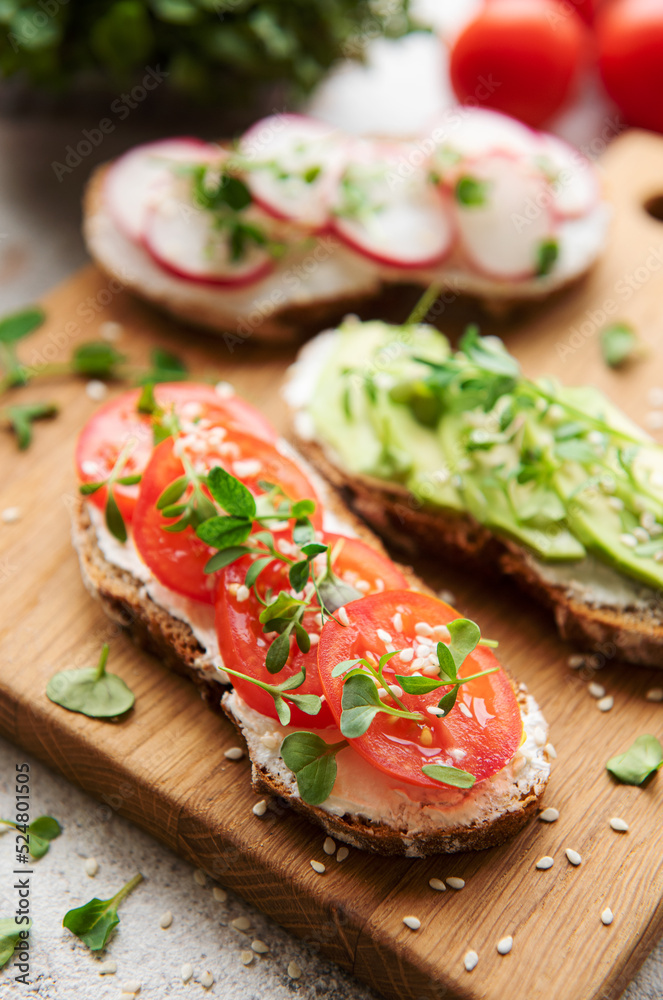 Different sandwiches with vegetables and microgreens Different sandwiches with vegetables and microgreens