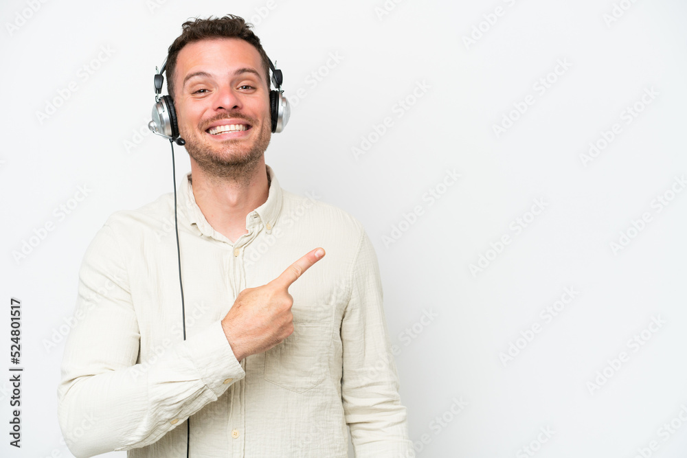 Telemarketer caucasian man working with a headset isolated on white background pointing to the side to present a product Telemarketer caucasian man working with a headset isolated on white background pointing to the side to present a product