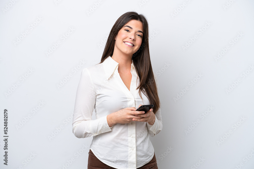 Young Brazilian woman isolated on white background sending a message with the mobile Young Brazilian woman isolated on white background sending a message with the mobile