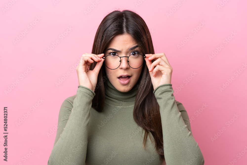Young Brazilian woman isolated on pink background With glasses and frustrated expression Young Brazilian woman isolated on pink background With glasses and frustrated expression