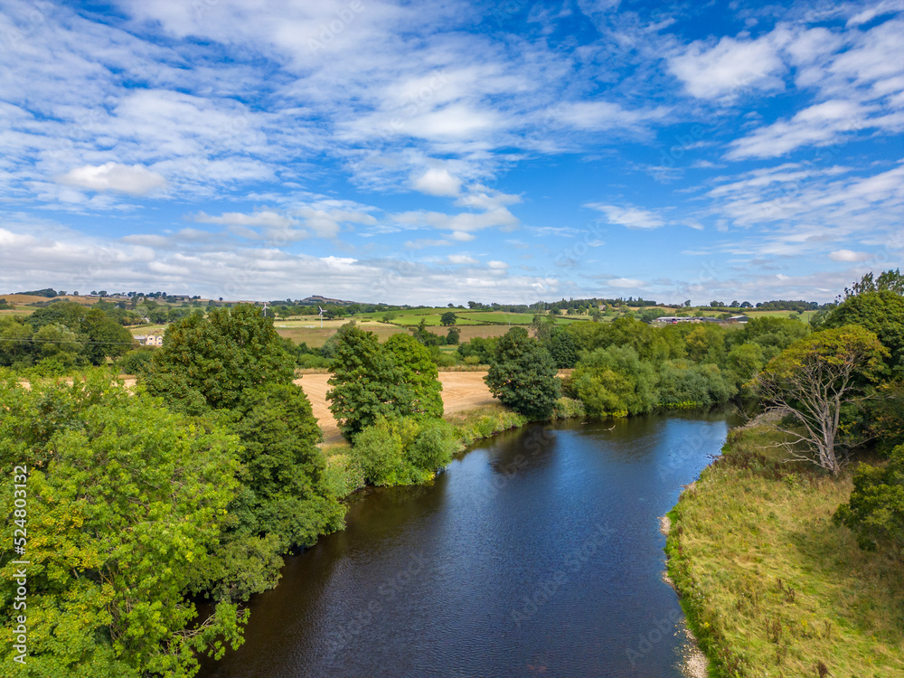 Aerial view of the River Wharfe. Landscape on a sunny, scattered cloud, day featuring North Yorkshire countryside.