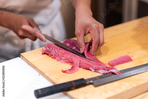 Cut tuna by chef, wooden floor