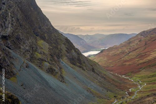 Stunning colorful landscape image of view down Honister Pass to Buttermere from Dale Head in Lake District during Autumn sunset