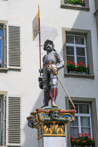 Fountain 'Standard Bearer' (Vennerbrunnen) on Rathausplatz in the center of Bern, Switzerland. The colorful statue of the Bernese standard bearer dressed in armor © haidamac
