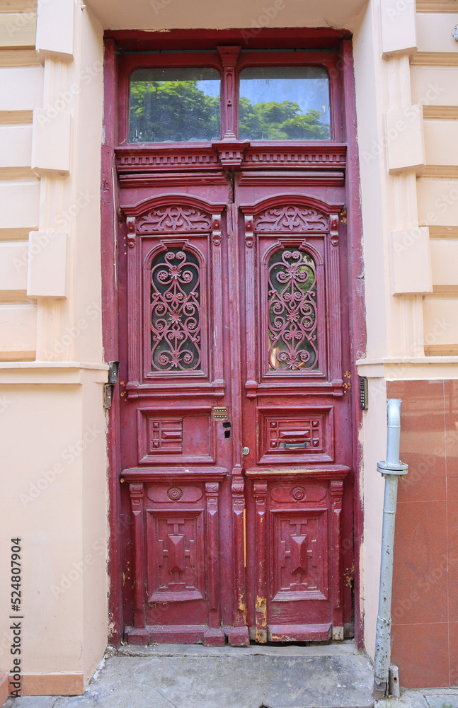 Vintage red wooden door in downtown of Ivano-Frankivsk, Ukraine	
