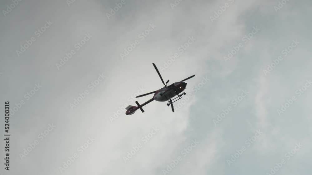 Hochwald, Oybin, Germany . August 20, 2022. The rescue helicopter hovers over the landscape and monitors the situation. The helicopter is waiting for a signal to intervene. Hochwald, Oybin, Germany . August 20, 2022. The rescue helicopter hovers over the landscape and monitors the situation. The helicopter is waiting for a signal to intervene.