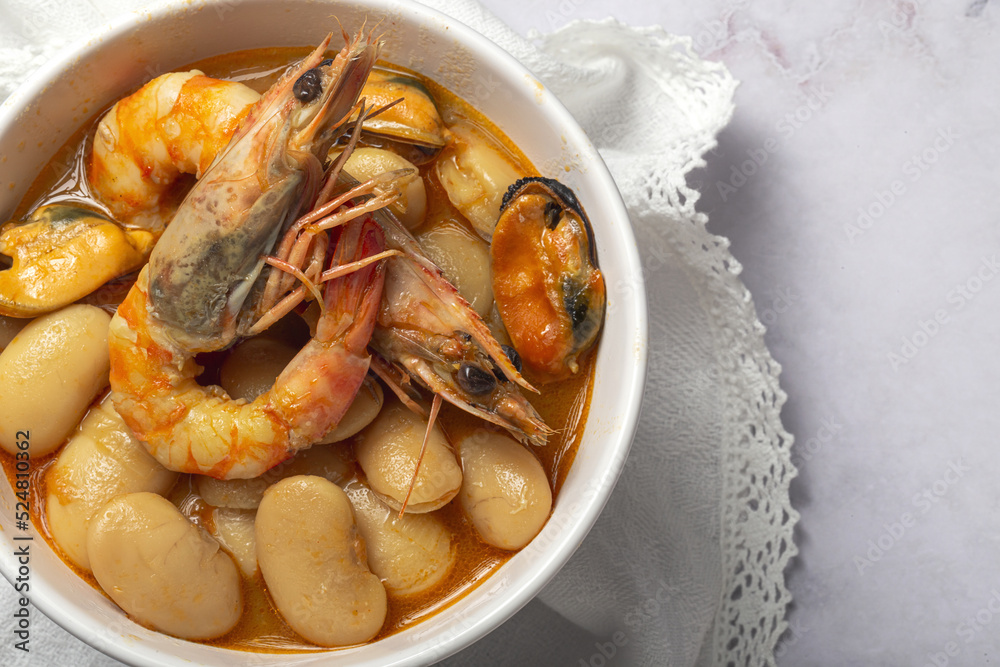 Bowl with typical beans stew with prawns shrimps and mussels Bowl with typical beans stew with prawns shrimps and mussels