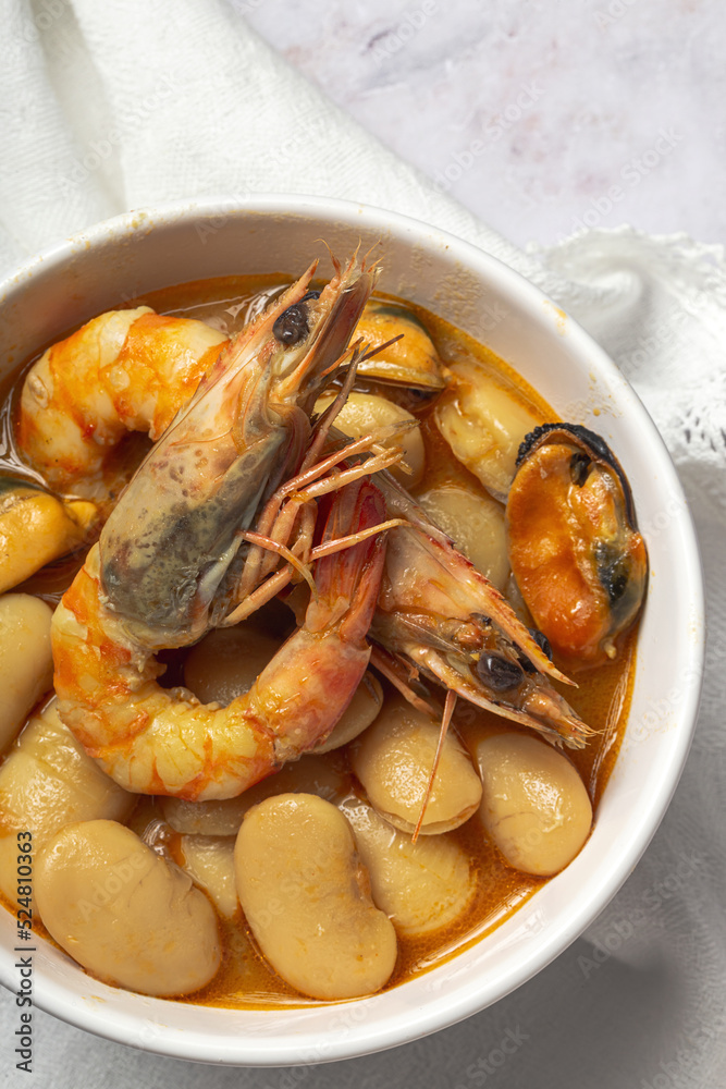 Bowl with typical beans stew with prawns shrimps and mussels Bowl with typical beans stew with prawns shrimps and mussels