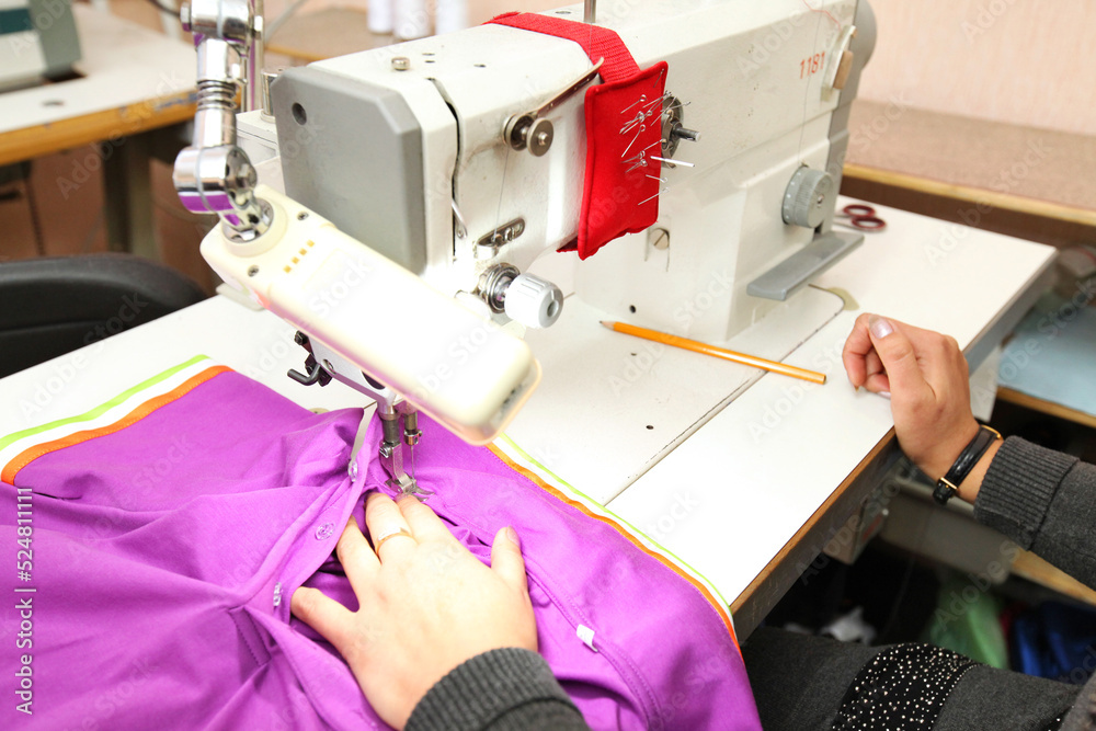 Shop for tailoring. A woman creates clothes on a sewing machine. Fashion industry for people. Stylish fashionista woman creating new cloth design collection. Tailor and sewing. 