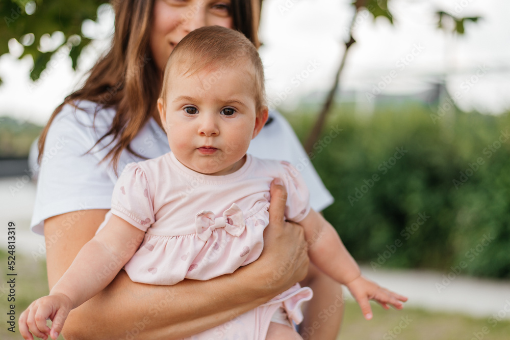 Fototapeta premium Little girl toddler with her mother in the park