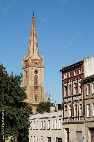 View of the old tenement houses and the tower of the church of the Holy Cross in Inowrocław, Poland.